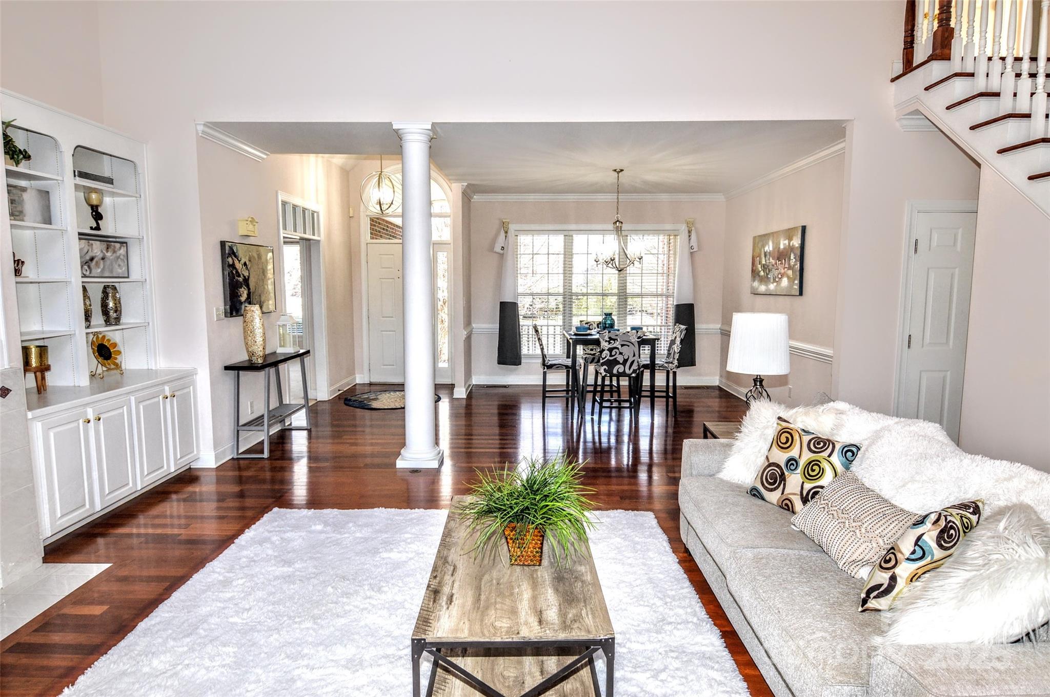 125 Eaglecrest Drive Matthews, NC 28104 - Photo 5 of 28 a living room with furniture floor to ceiling window and wooden floor