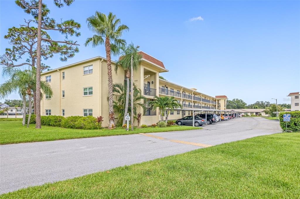 1450 Heather Ridge Boulevard, Unit 305 Dunedin, FL 34698 - Photo 1 of 1 a view of a house with a yard and table and chairs