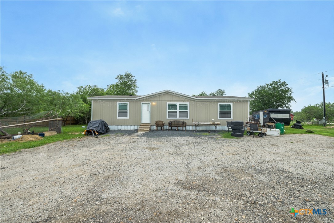 6497 Taylorsville Road Dale, TX 78616 - Photo 1 of 36 a view of a house with a backyard and a tree