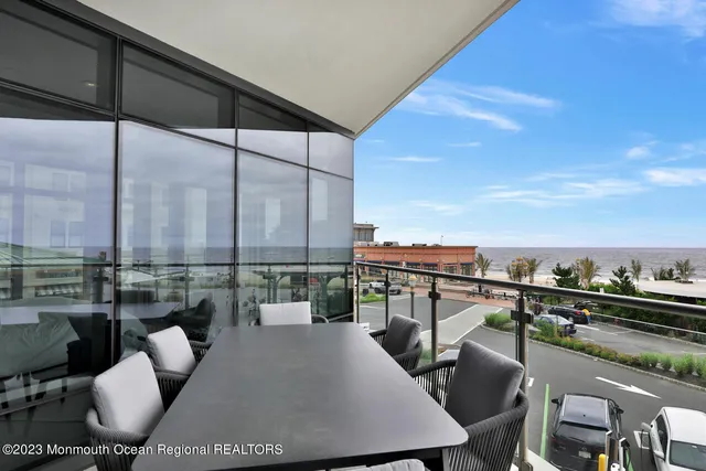 a view of roof deck with seating space and city view