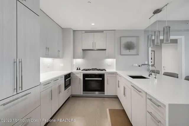 a kitchen with stainless steel appliances granite countertop a stove and a sink