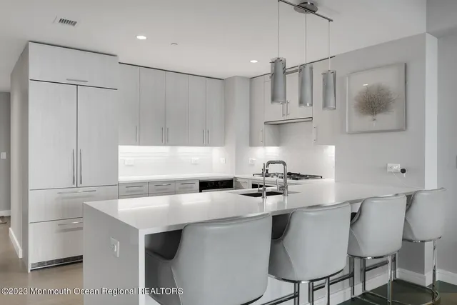 a kitchen with stainless steel appliances a sink stove and refrigerator