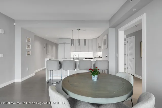 a dining room with furniture and wooden floor