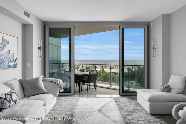 a living room with furniture and large windows