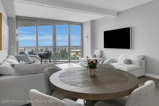 a living room with couches and a flat screen tv