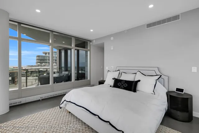 a bedroom with a large bed and a large window