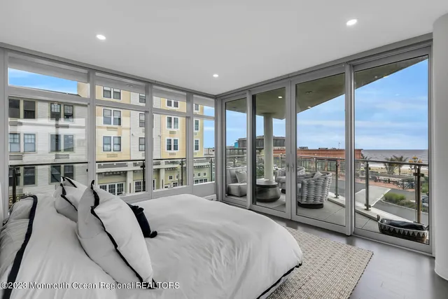 a spacious bedroom with a large bed and a balcony view