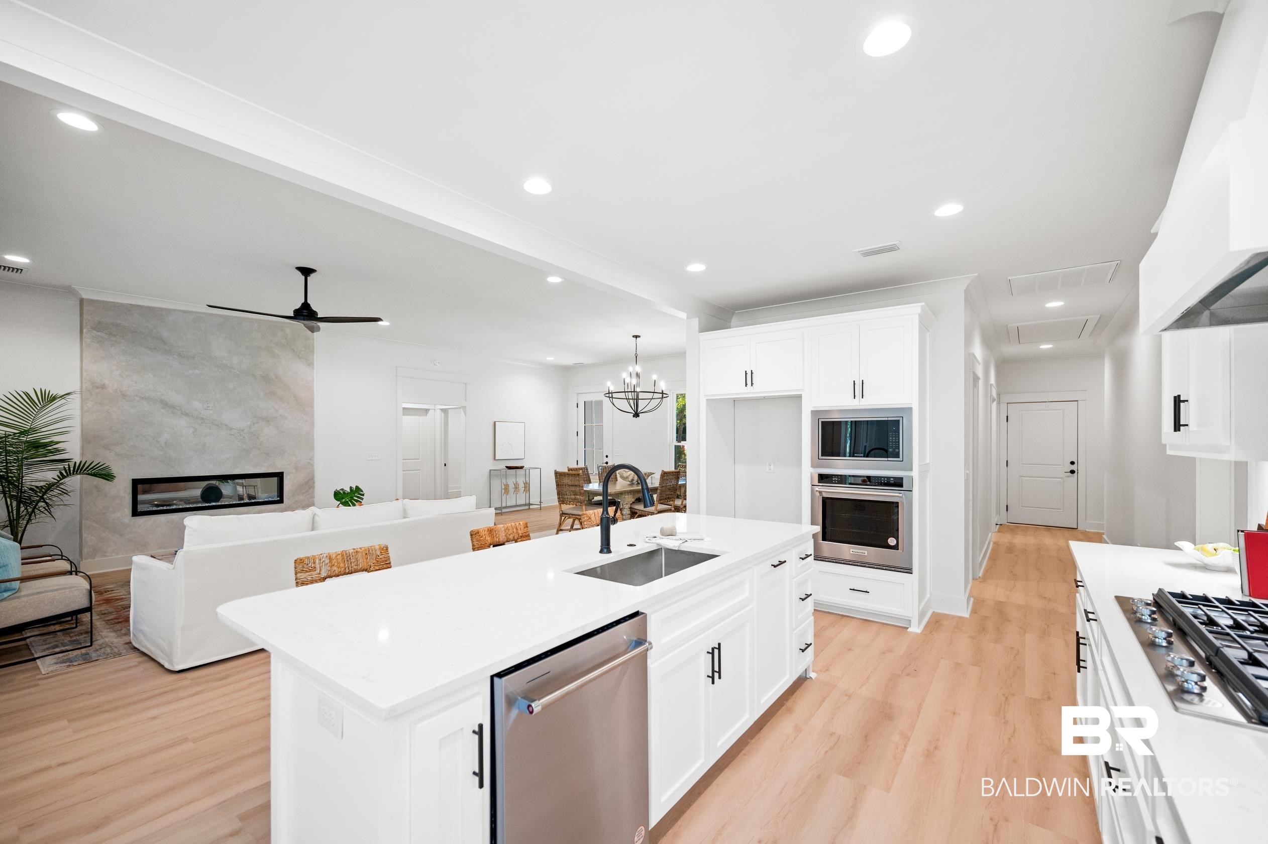 28889 Canal Road Orange Beach, AL 36561 - Photo 12 of 55 Kitchen featuring white cabinetry, sink, a center island with sink, and appliances with stainless steel finishes