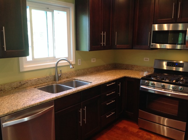 1808 Hatch Street Downers Grove, IL 60516 - Photo 7 of 20 a kitchen with granite countertop a sink a stove and cabinets