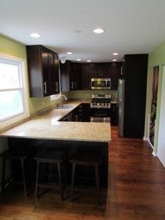 1808 Hatch Street Downers Grove, IL 60516 - Photo 8 of 20 a kitchen with stainless steel appliances granite countertop a table chairs sink refrigerator and microwave