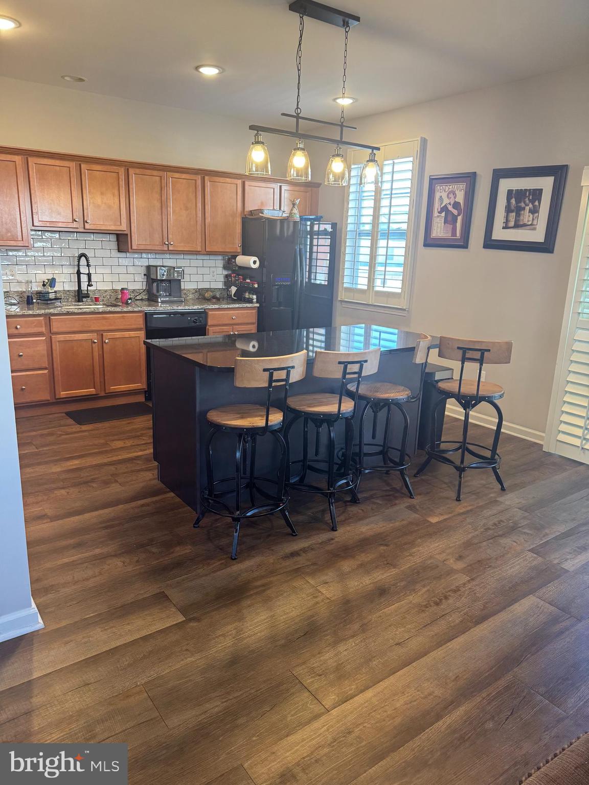 a kitchen with a table chairs refrigerator and cabinets