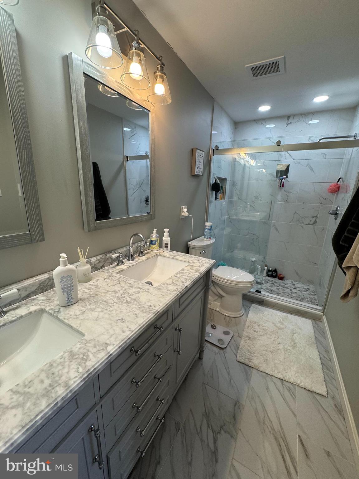 43 Poplar Street Glassboro, NJ 08028 - Photo 8 of 16 a bathroom with a granite countertop sink a toilet and a mirror