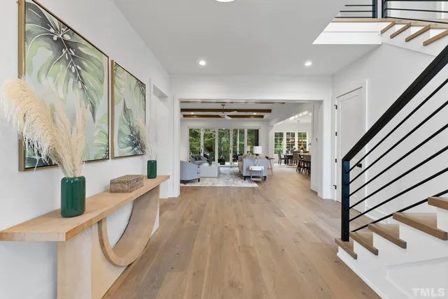 a living room with furniture a table and a large window