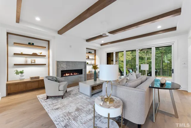 a large kitchen with kitchen island a sink white cabinets and stainless steel appliances
