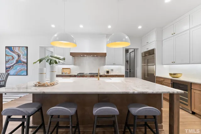 a kitchen with granite countertop white cabinets and a sink