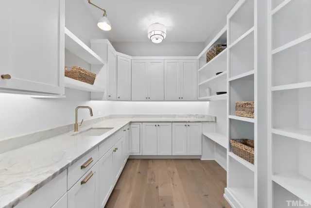 a kitchen with granite countertop white cabinets and white appliances