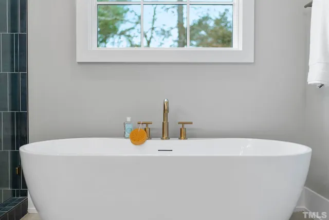a living room with furniture fireplace and a large window