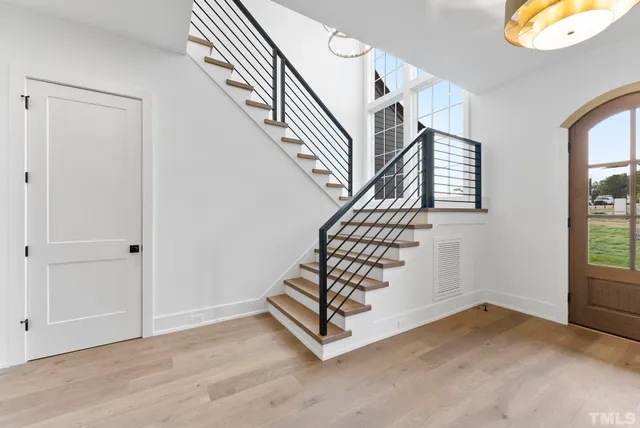 a view of entryway with wooden floor and stairs