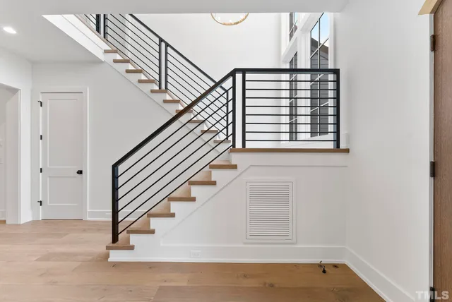 a view of entryway and hall with wooden floor