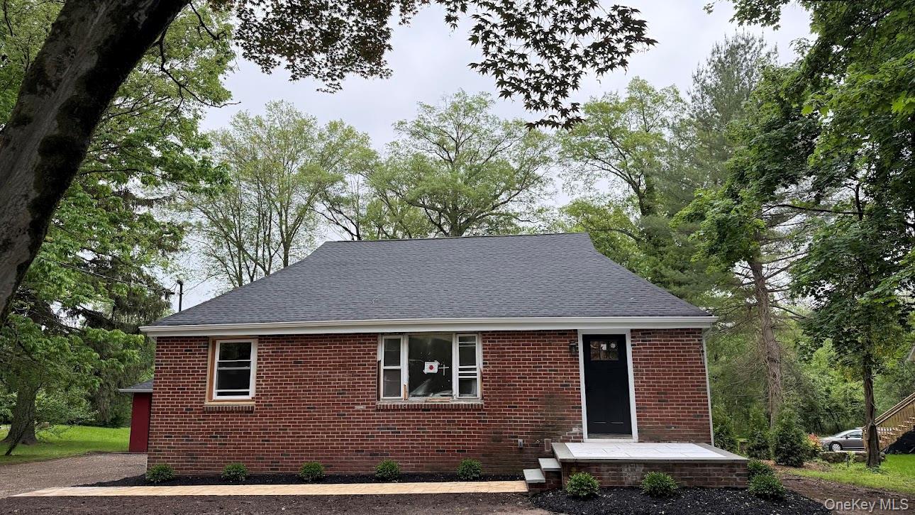 20 Pineview Road West Nyack, NY 10994 - Photo 4 of 36 a brick house with a yard plants and large tree