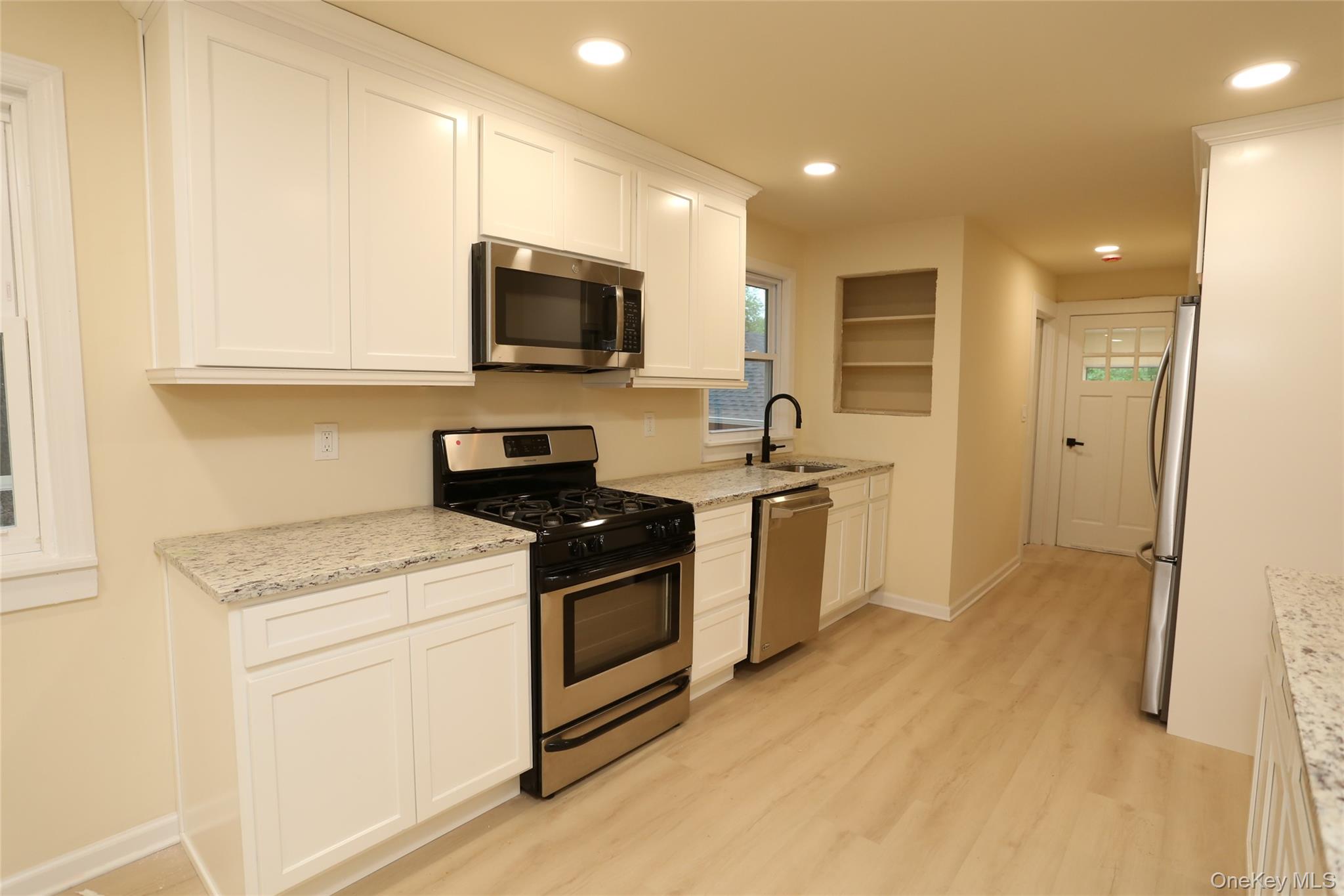 20 Pineview Road West Nyack, NY 10994 - Photo 7 of 36 a kitchen with a sink stove and microwave