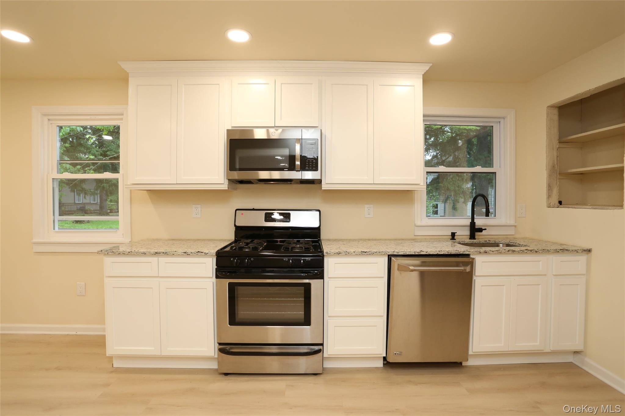20 Pineview Road West Nyack, NY 10994 - Photo 8 of 36 a kitchen with stainless steel appliances a stove sink microwave and cabinets
