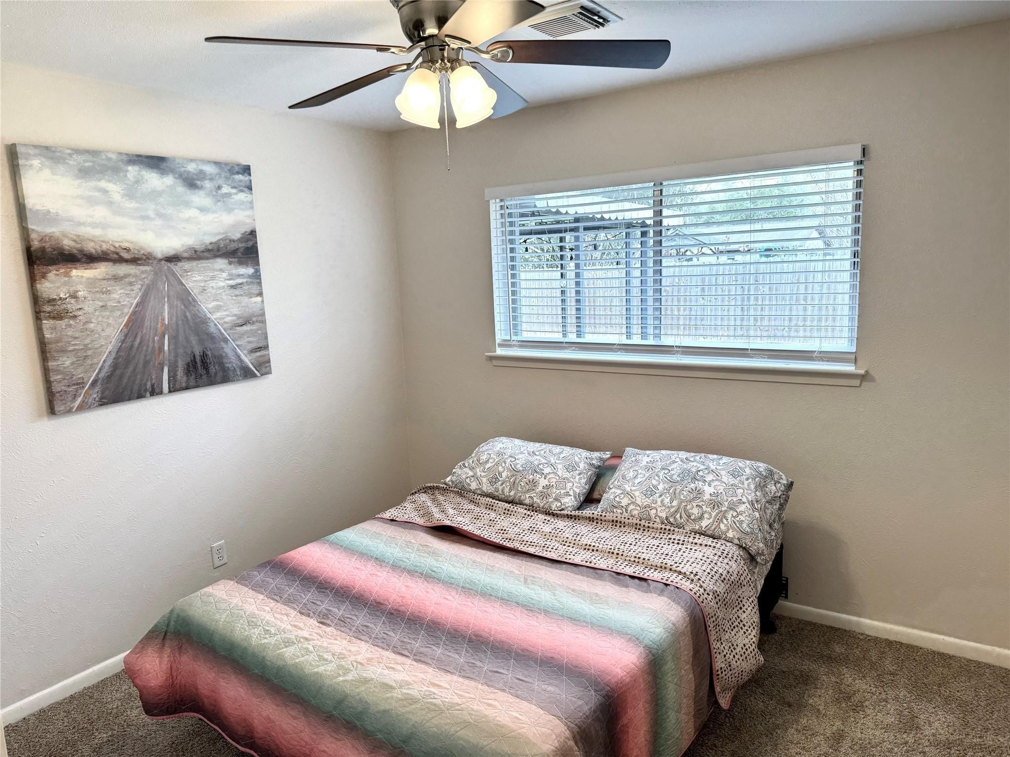 11311 Caribbean Lane Houston, TX 77089 - Photo 12 of 21 a bedroom with a bed and a window