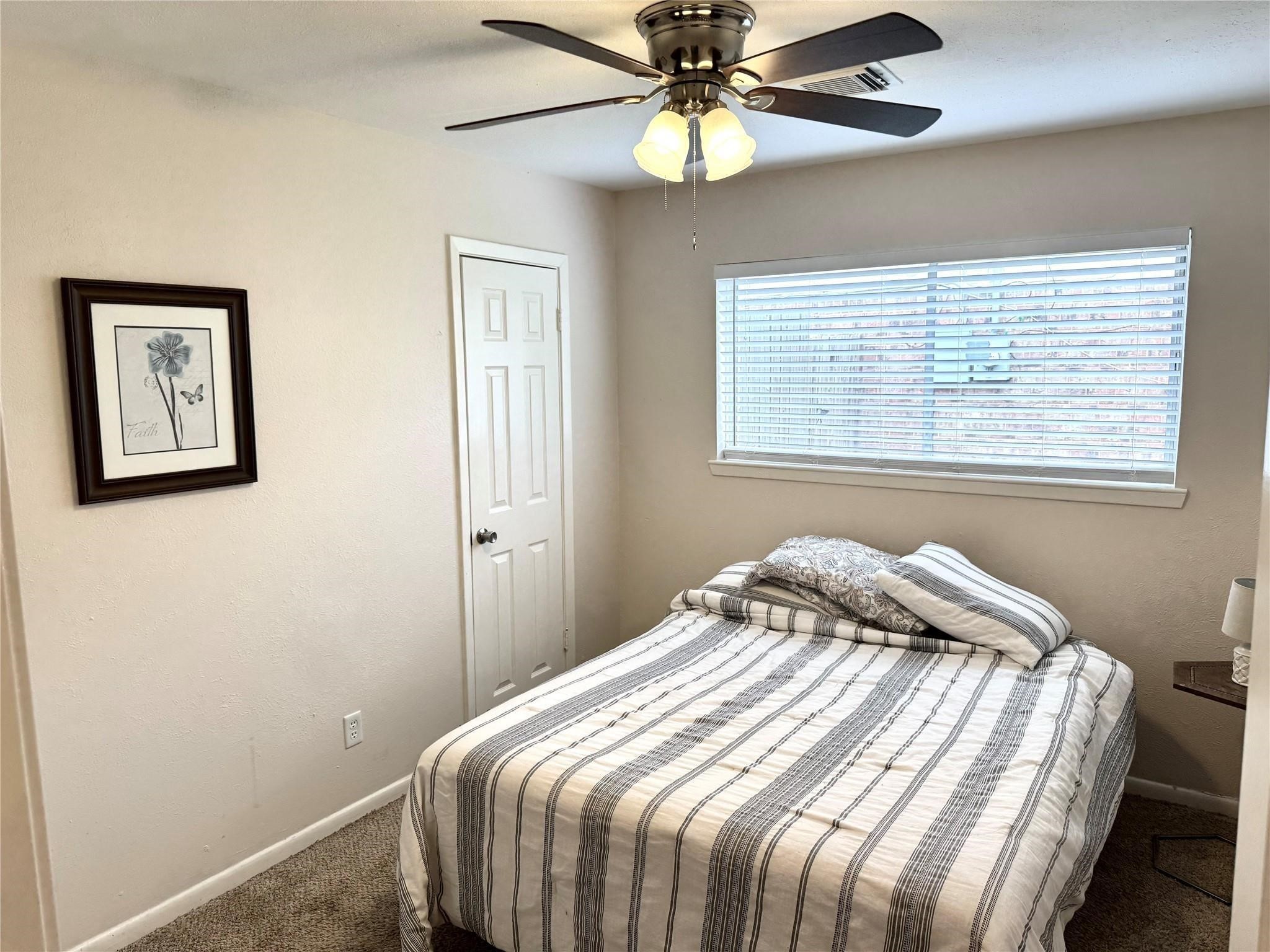 11311 Caribbean Lane Houston, TX 77089 - Photo 13 of 21 a bedroom with a bed and a window