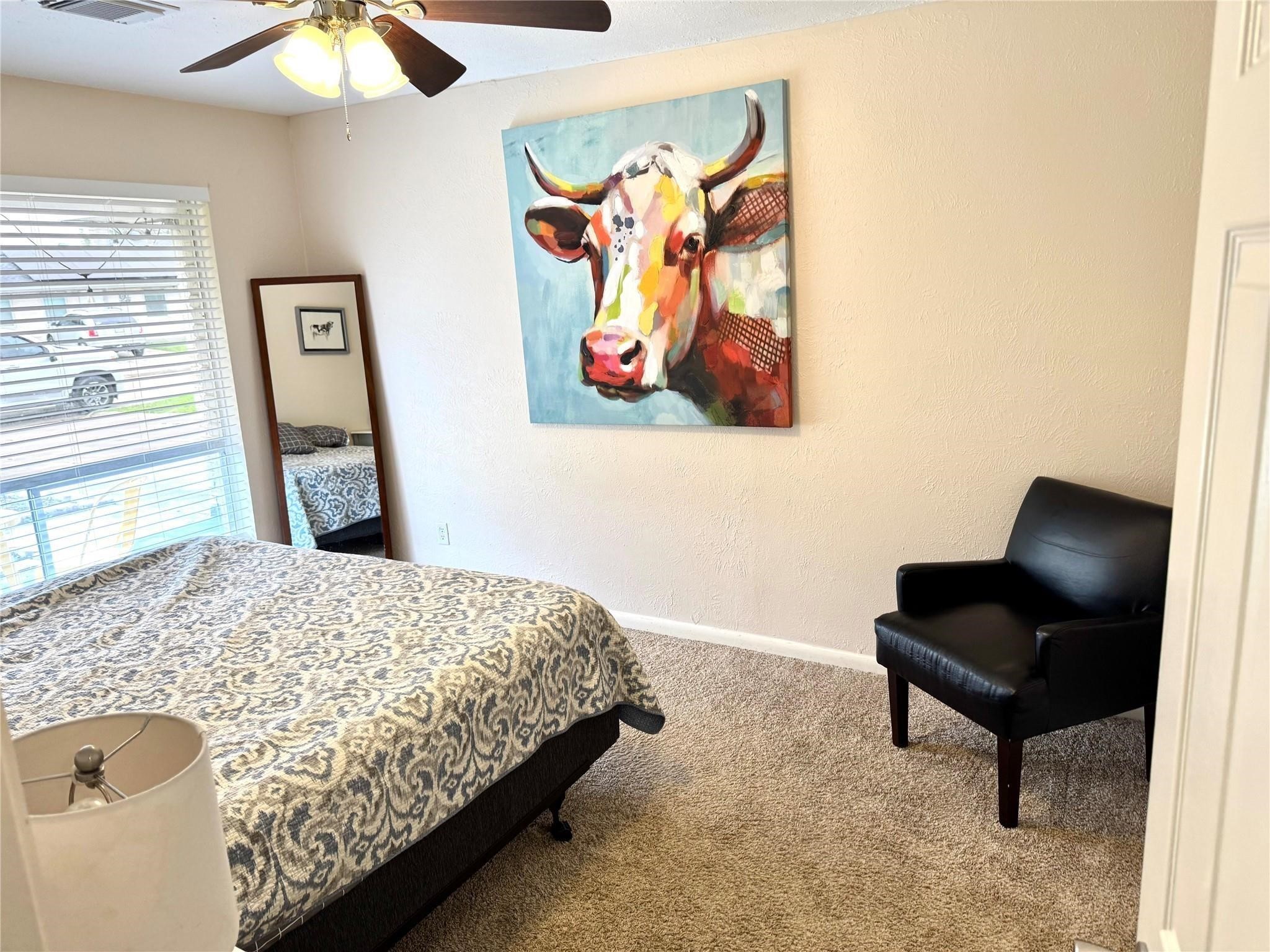 11311 Caribbean Lane Houston, TX 77089 - Photo 15 of 21 a bedroom with a bed and a chandelier