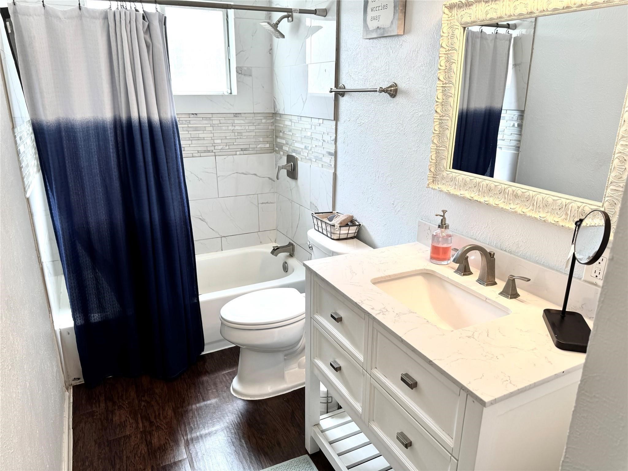 11311 Caribbean Lane Houston, TX 77089 - Photo 16 of 21 a bathroom with a sink a toilet and shower curtain