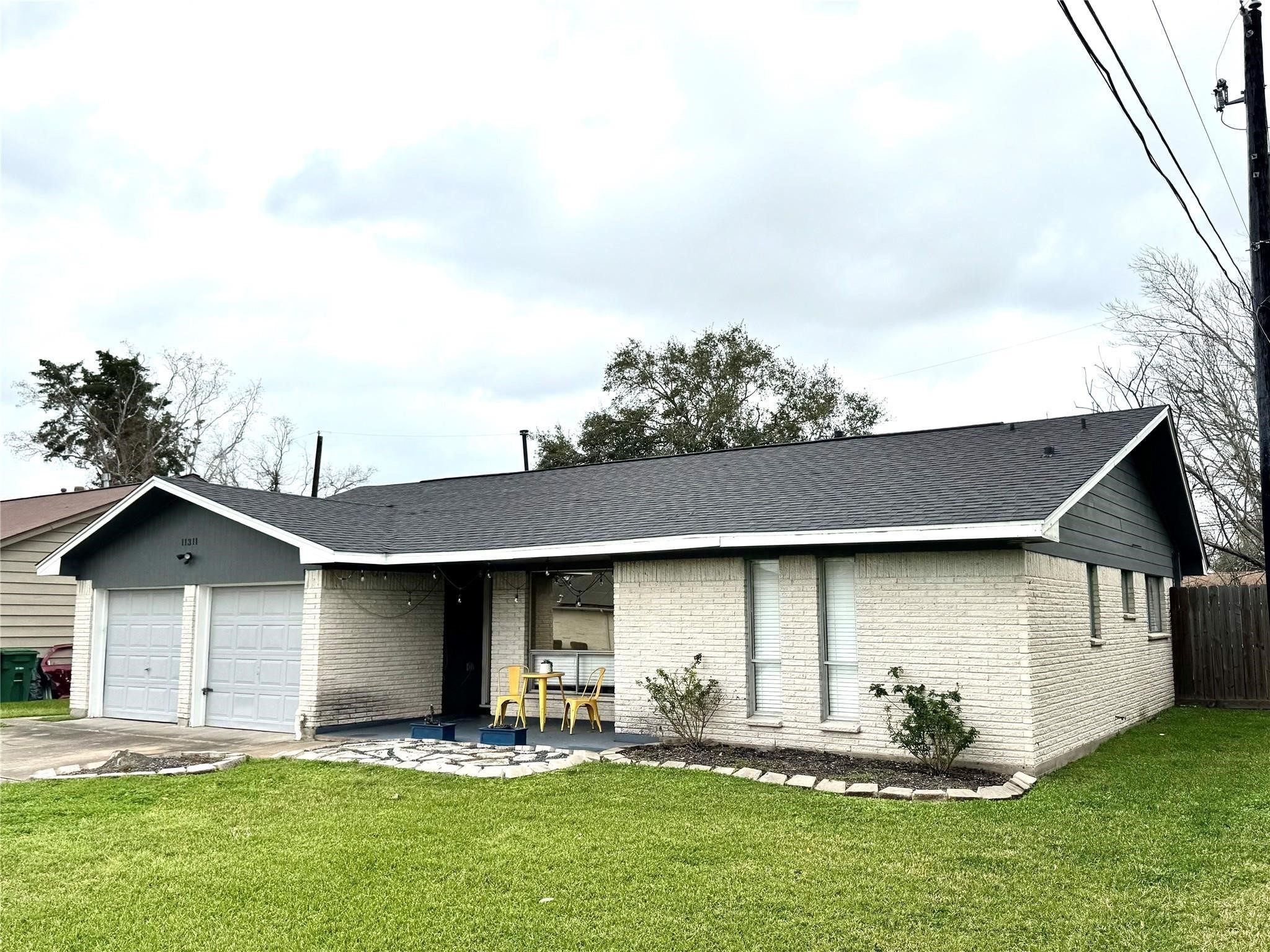 11311 Caribbean Lane Houston, TX 77089 - Photo 2 of 21 a front view of a house with a yard and garage