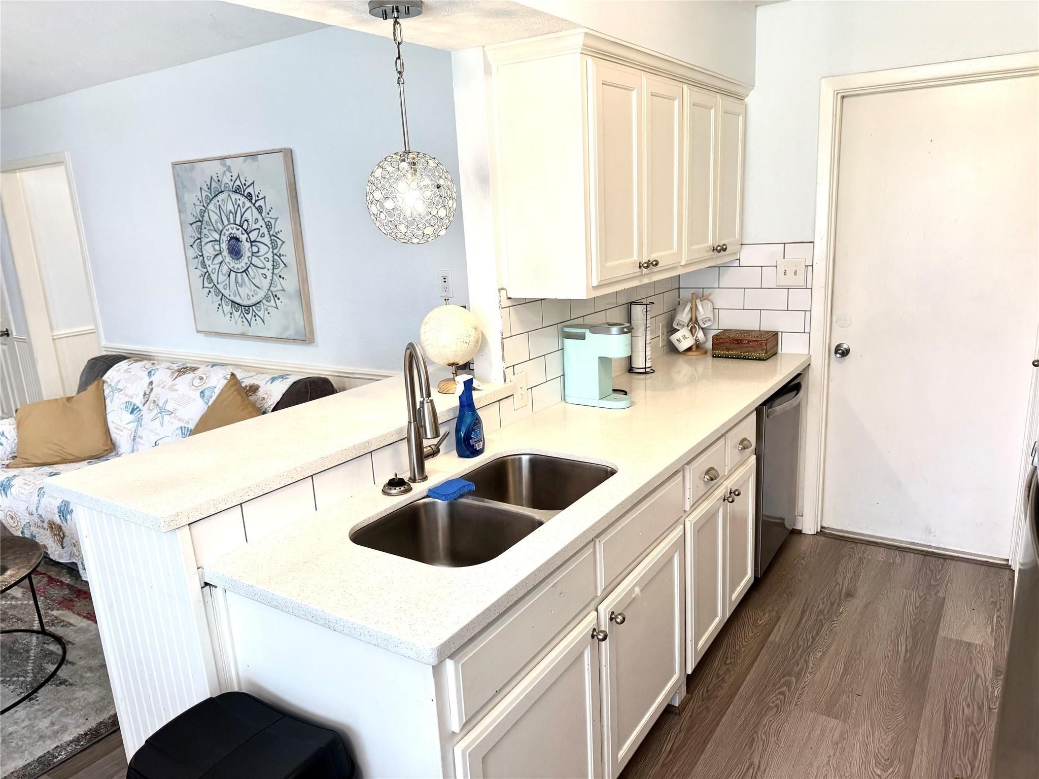 11311 Caribbean Lane Houston, TX 77089 - Photo 7 of 21 a kitchen with a sink and a refrigerator