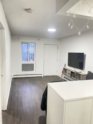 a view of a livingroom with furniture and a flat screen tv