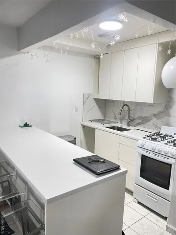 a kitchen with a stove and a white cabinets