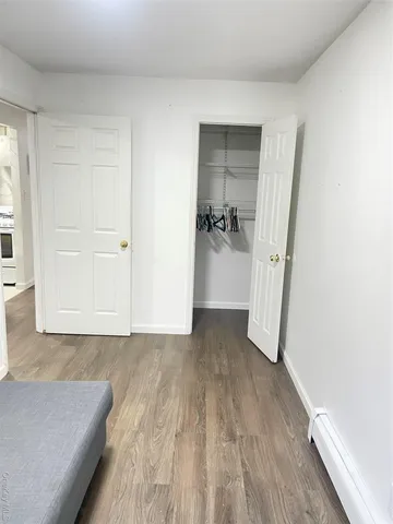 a view of a hallway view with wooden floor and staircase