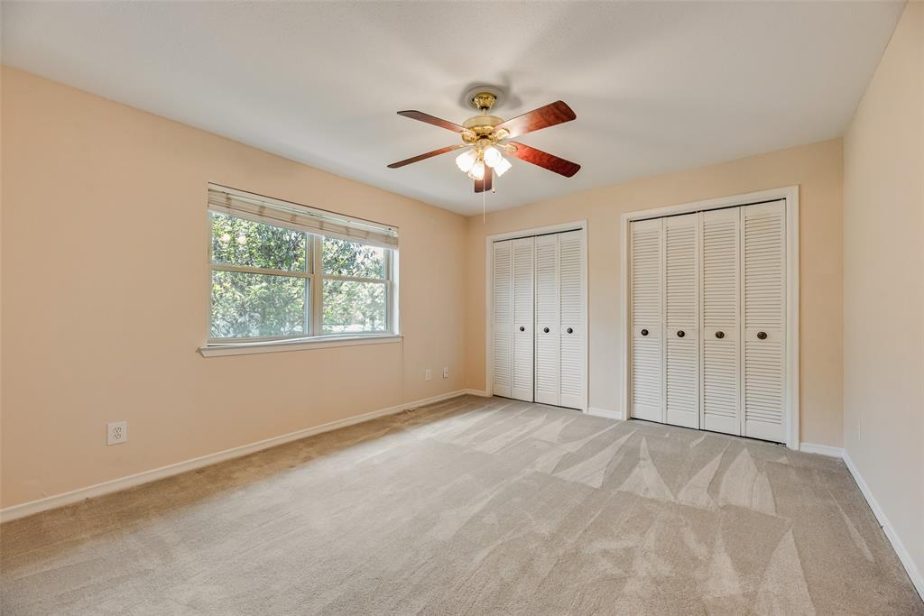 4988 Thunder Road Dallas, TX 75244 - Photo 23 of 32 Bedroom featuring a window with blinds, two bi-fold closets, and a ceiling fan with light fixture