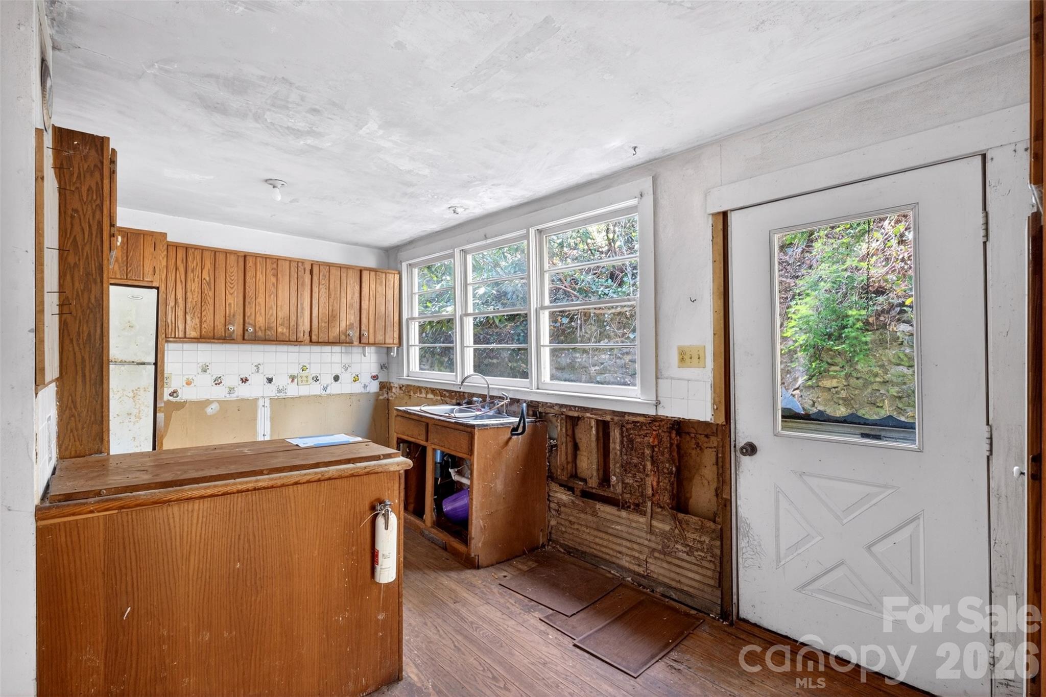 105 Poplar Street Saluda, NC 28773 - Photo 11 of 37 a view of kitchen with furniture and large window