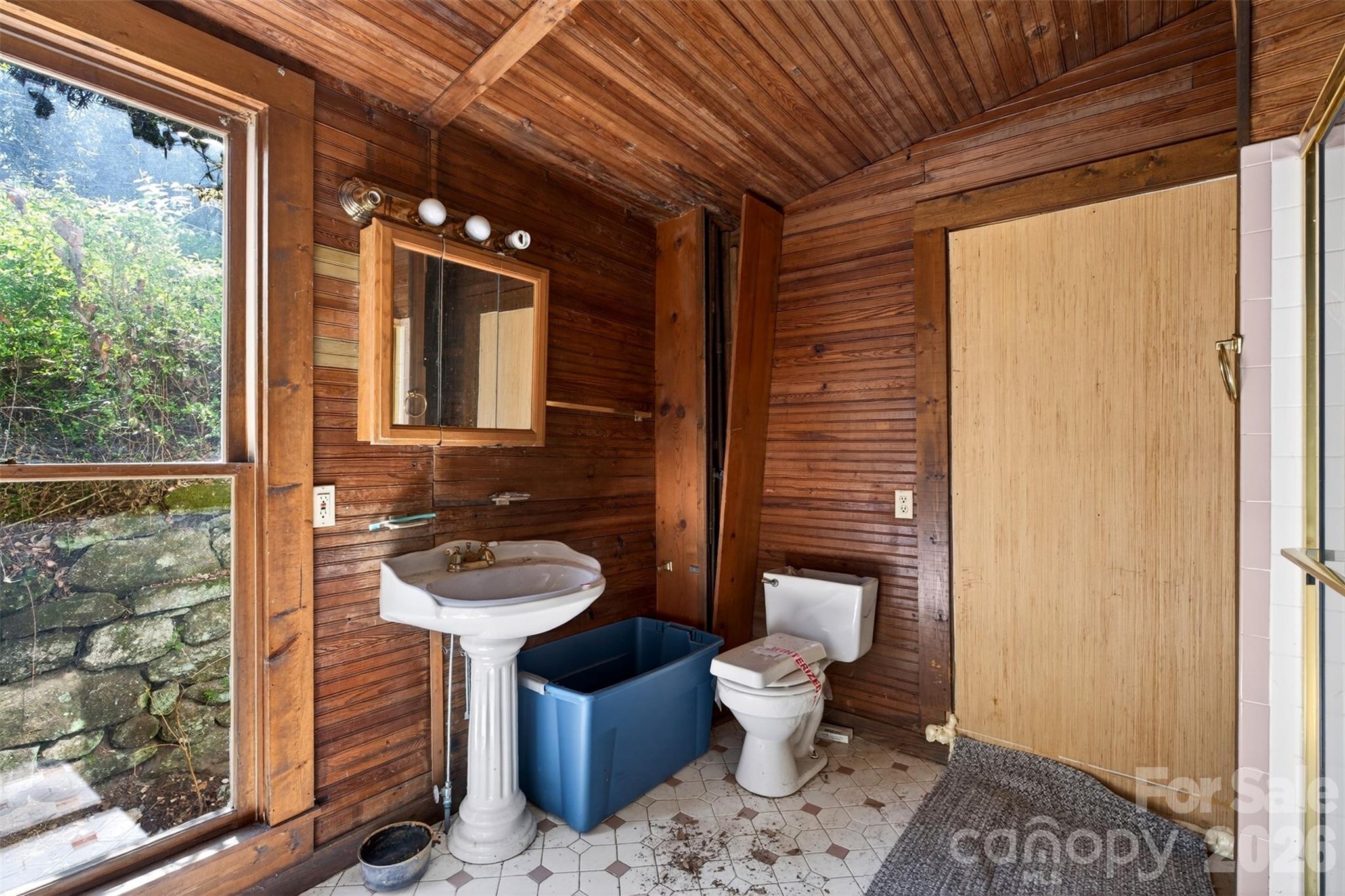 105 Poplar Street Saluda, NC 28773 - Photo 15 of 37 a bathroom with a toilet sink and mirror