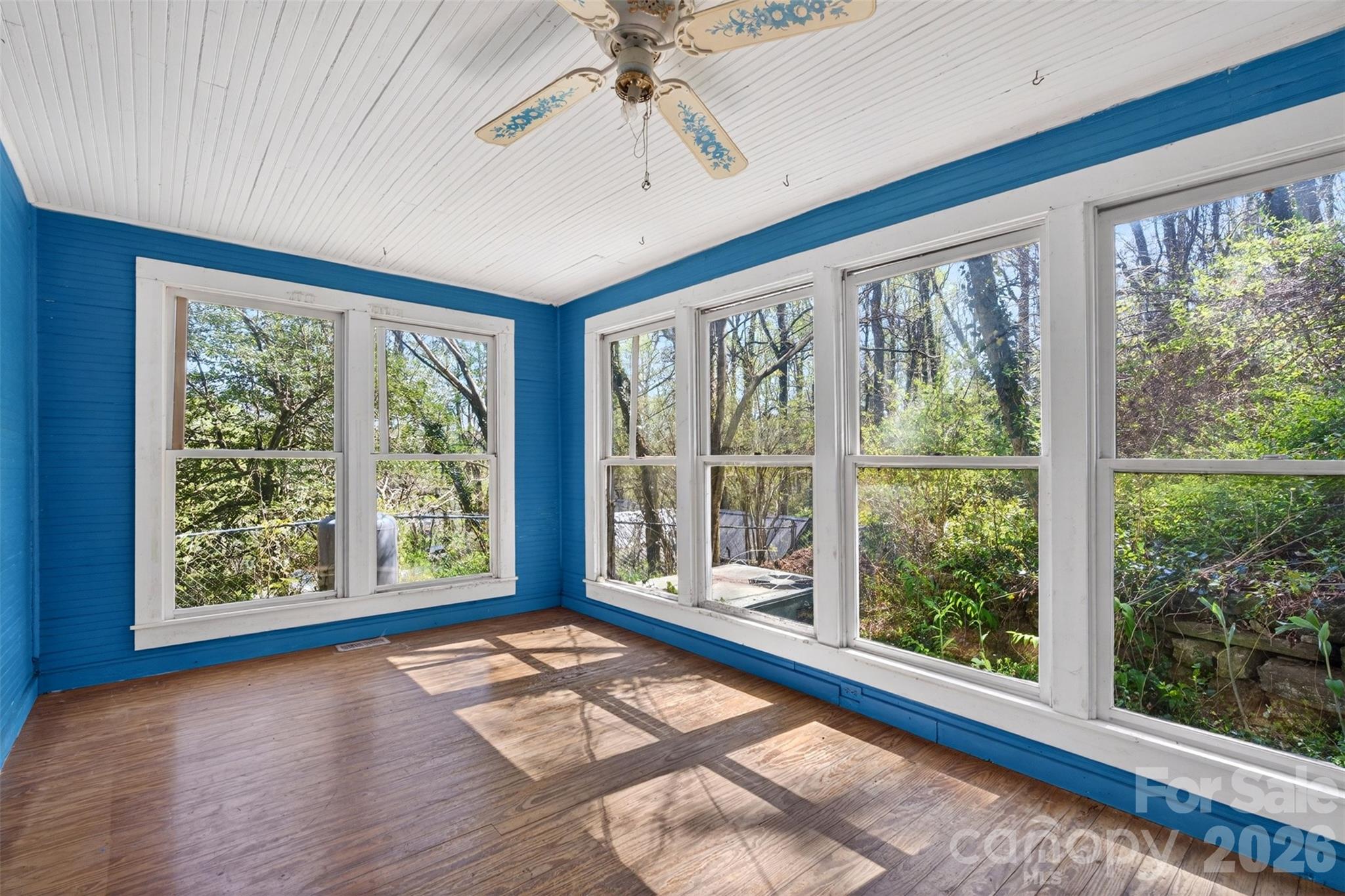 105 Poplar Street Saluda, NC 28773 - Photo 16 of 37 a view of an empty room with a window and wooden floor