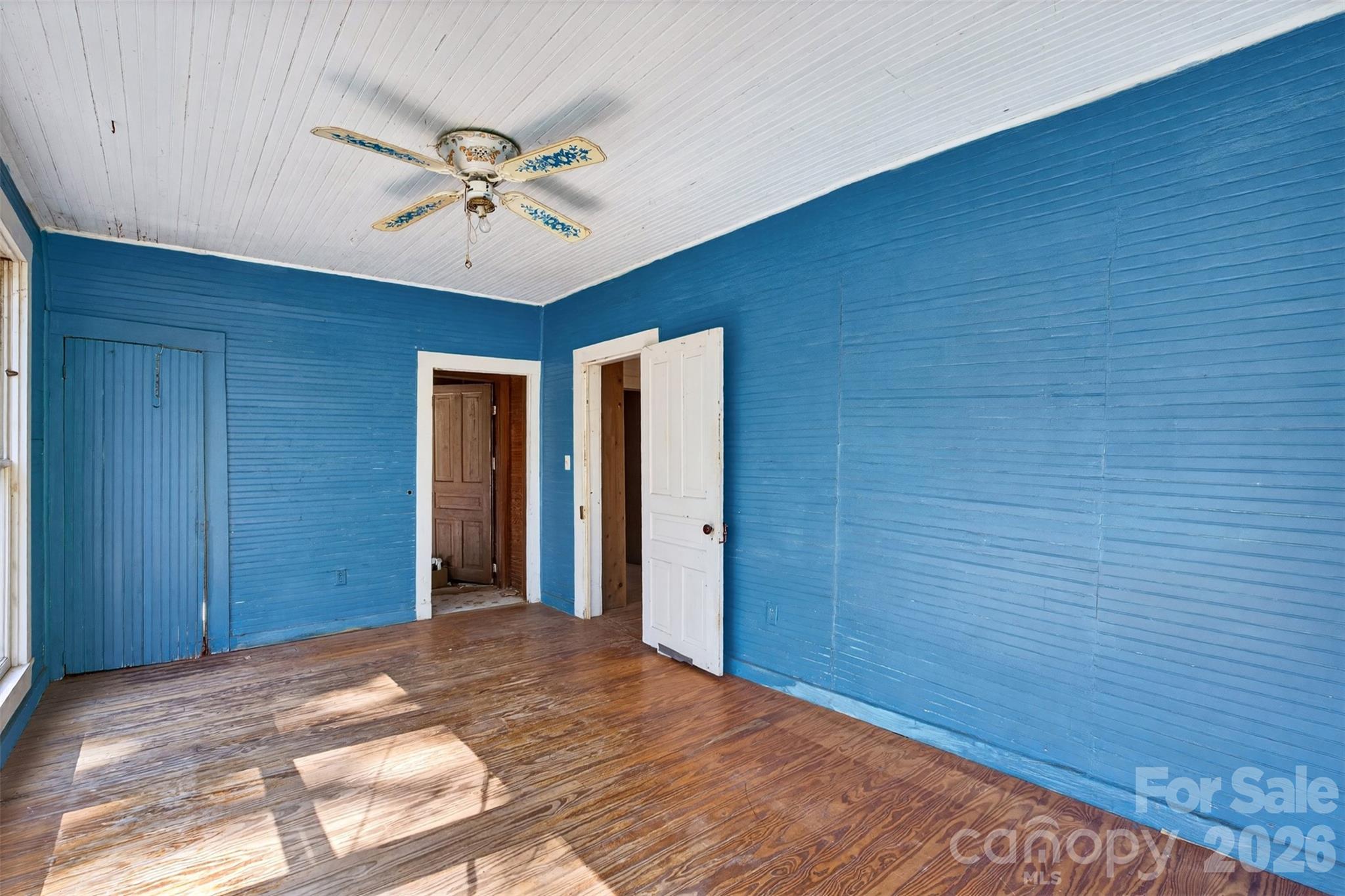105 Poplar Street Saluda, NC 28773 - Photo 17 of 37 a view of a livingroom with a ceiling fan and wooden floor