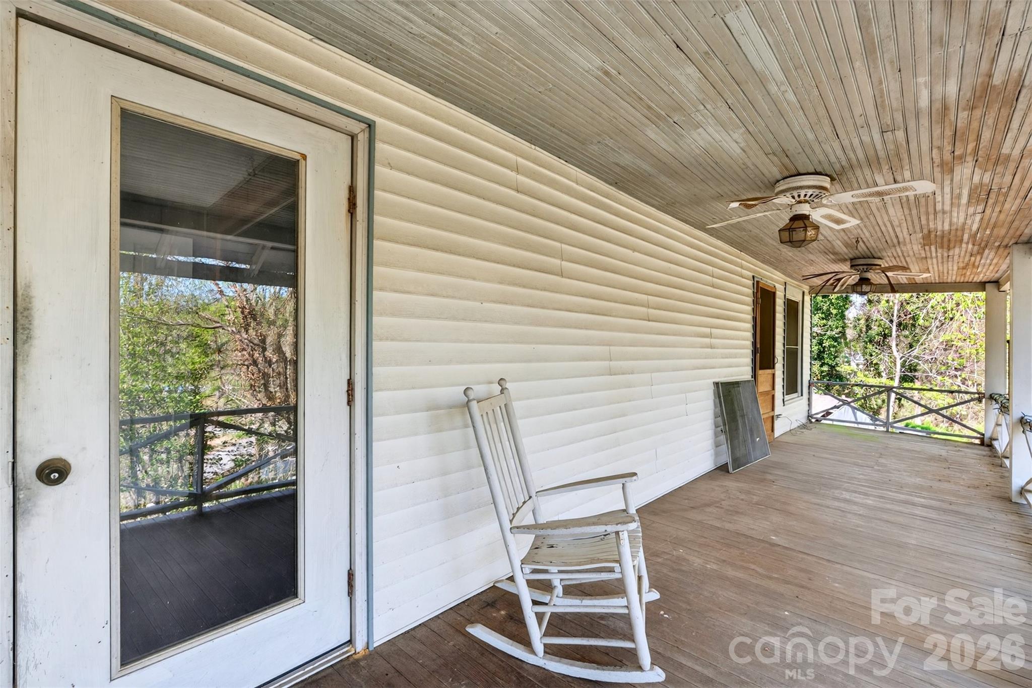 105 Poplar Street Saluda, NC 28773 - Photo 23 of 37 a view of a patio with table and chairs and couches with wooden floor
