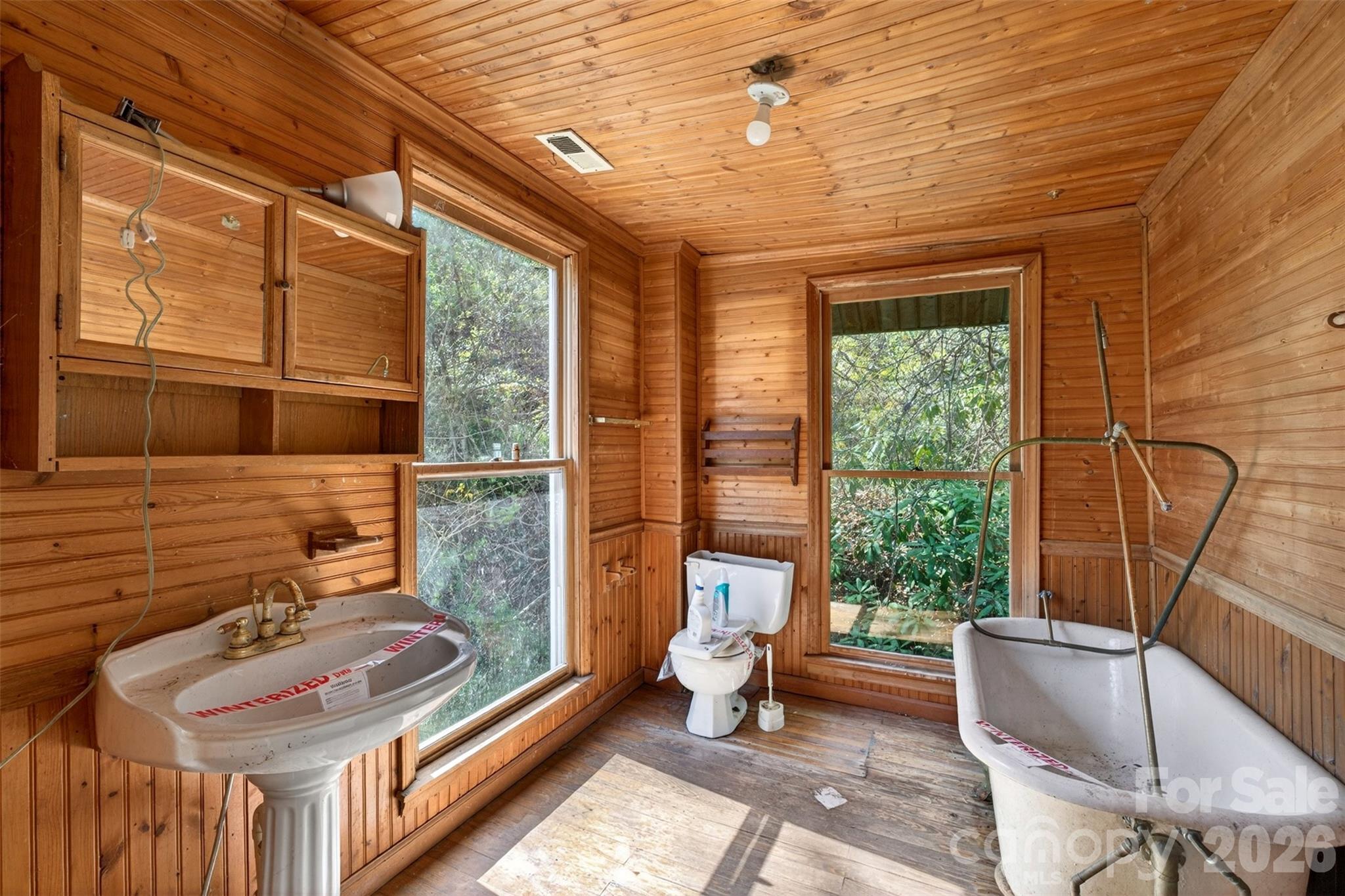 105 Poplar Street Saluda, NC 28773 - Photo 25 of 37 a bathroom with a sink a toilet and tub