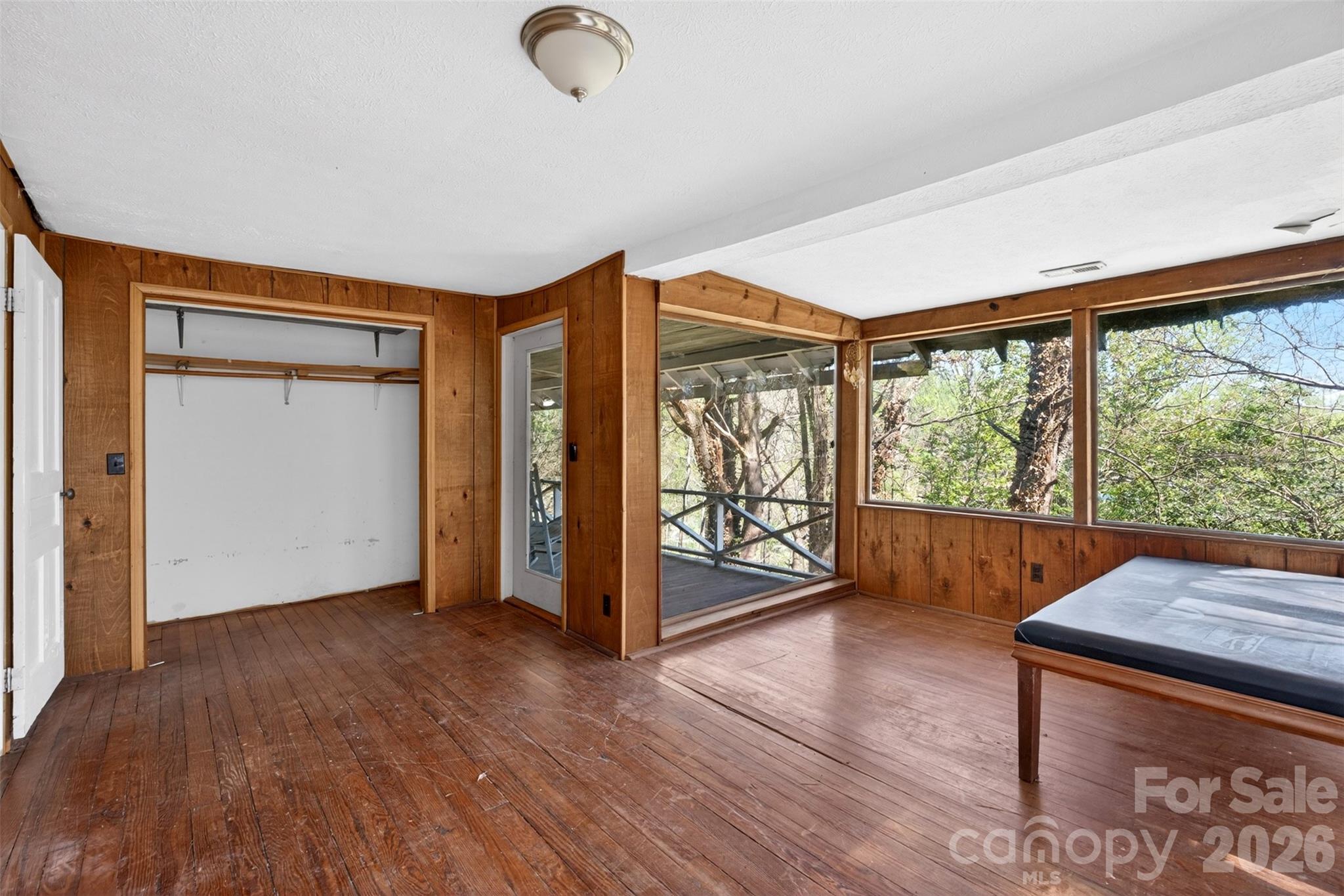 105 Poplar Street Saluda, NC 28773 - Photo 26 of 37 an empty room with wooden floor and windows