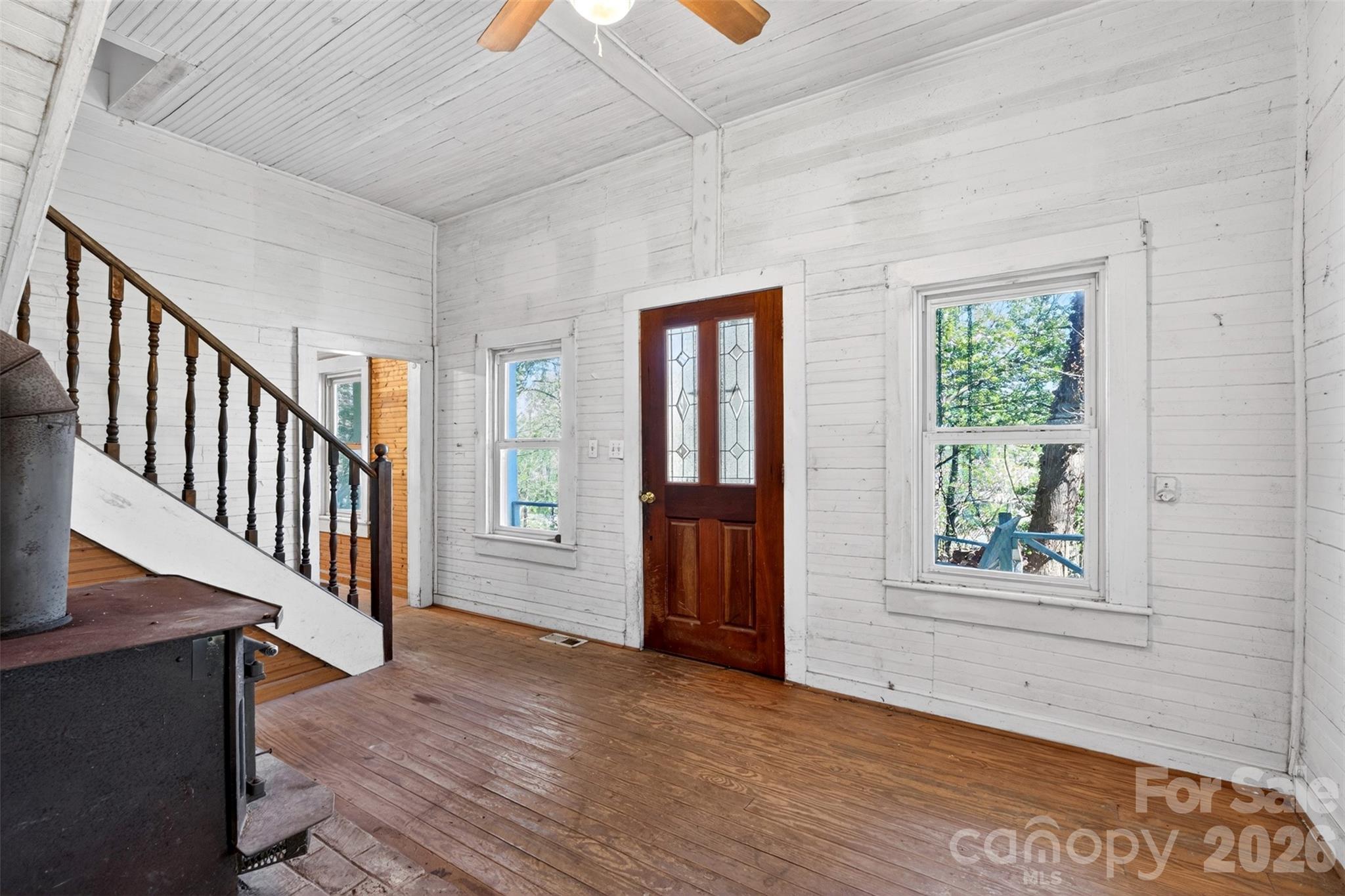 105 Poplar Street Saluda, NC 28773 - Photo 5 of 37 a view of an entryway with wooden floor and windows