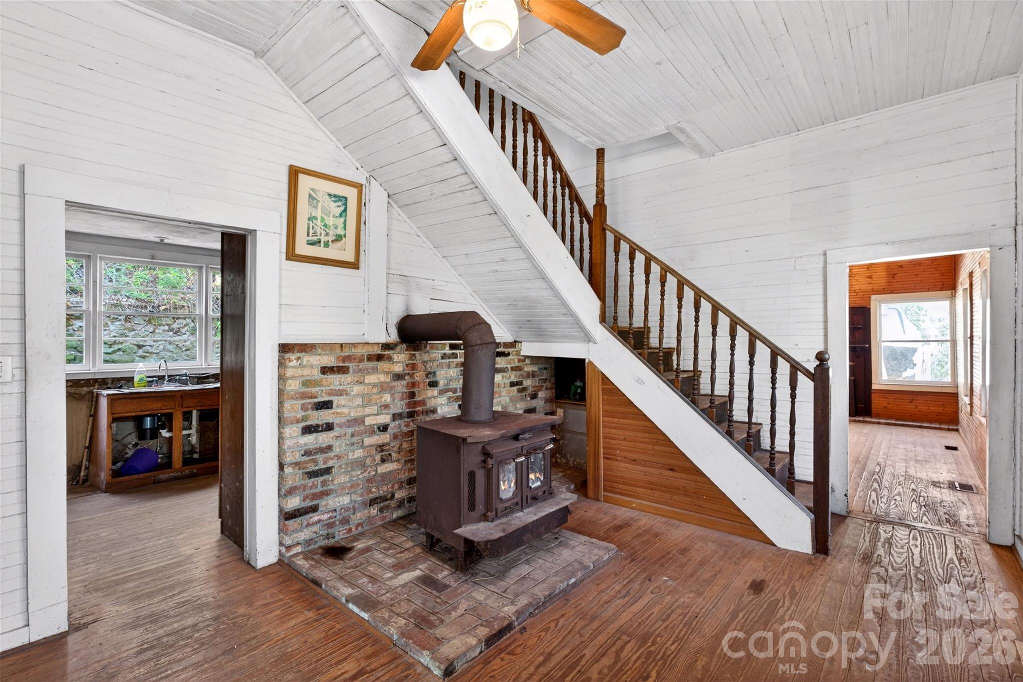 105 Poplar Street Saluda, NC 28773 - Photo 6 of 37 a view of staircase with wooden floor and a large window