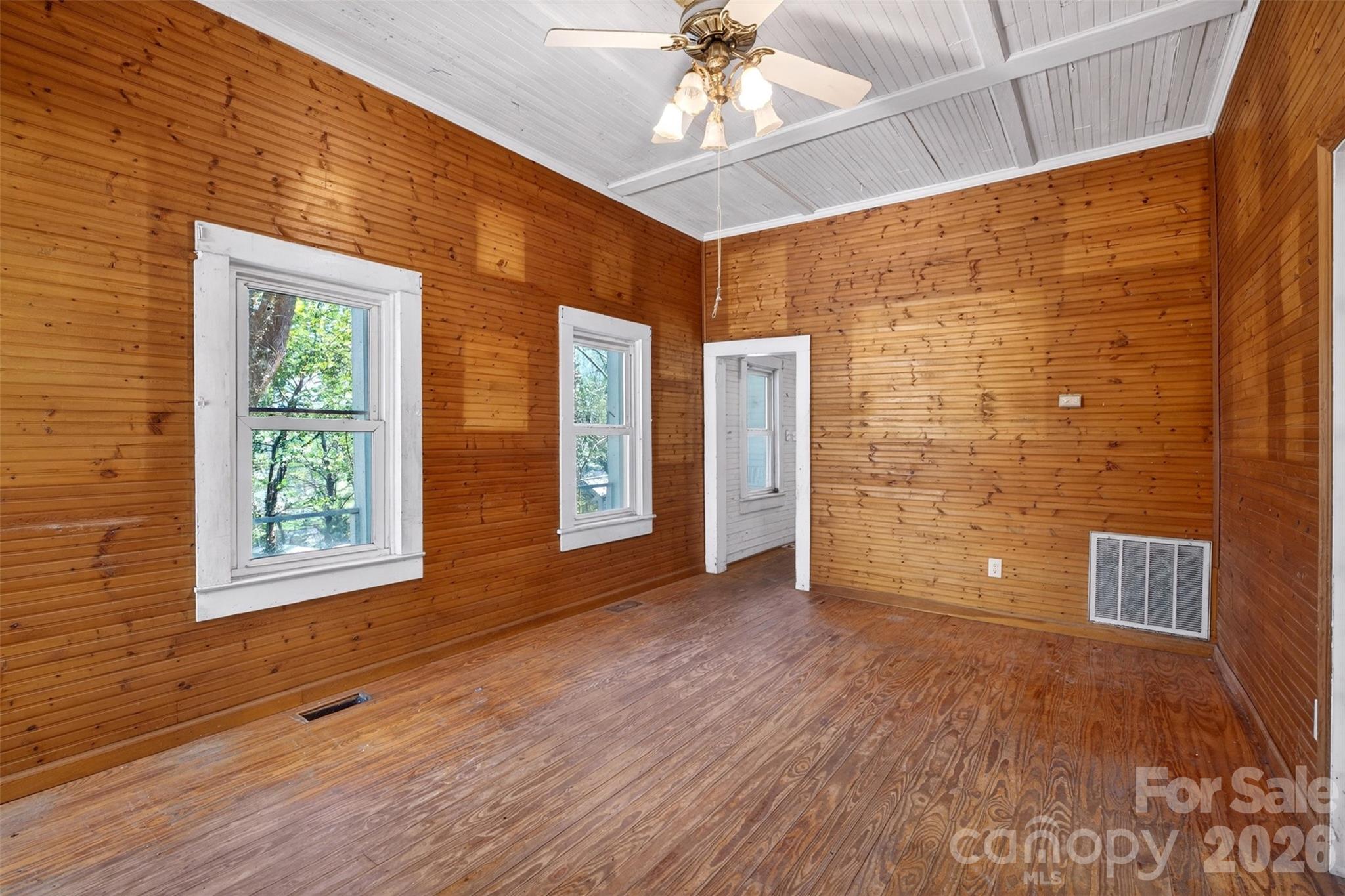 105 Poplar Street Saluda, NC 28773 - Photo 8 of 37 a view of an empty room with a window and wooden floor