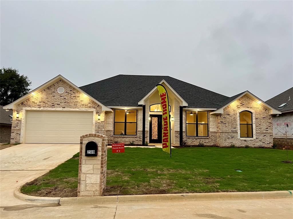 2509 Windmill Lane Longview, TX 75601 - Photo 1 of 35 View of front of property with brick siding, concrete driveway, and a garage