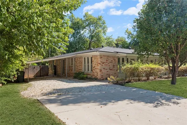 a front view of a house with a yard and a garage