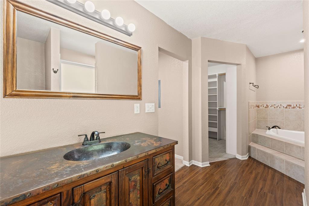 919 North 11th Street Temple, TX 76501 - Photo 18 of 26 a bathroom with a granite countertop sink and a mirror