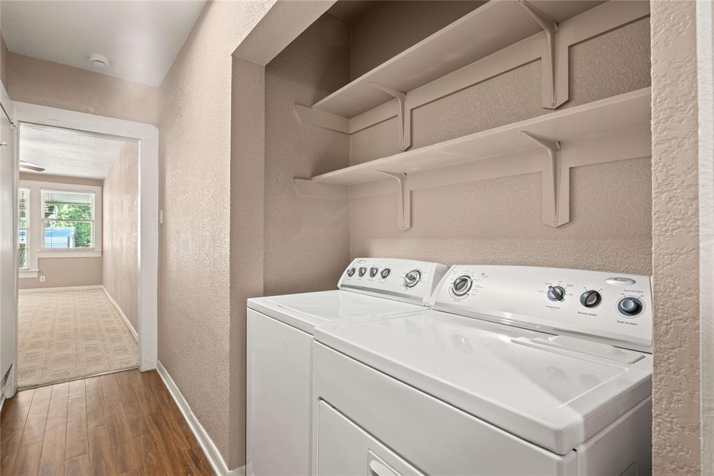 919 North 11th Street Temple, TX 76501 - Photo 23 of 26 a view of washer and dryer with kitchen in the background